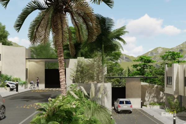 A gated residential area with a palm tree, modern buildings, and lush greenery under a clear sky.