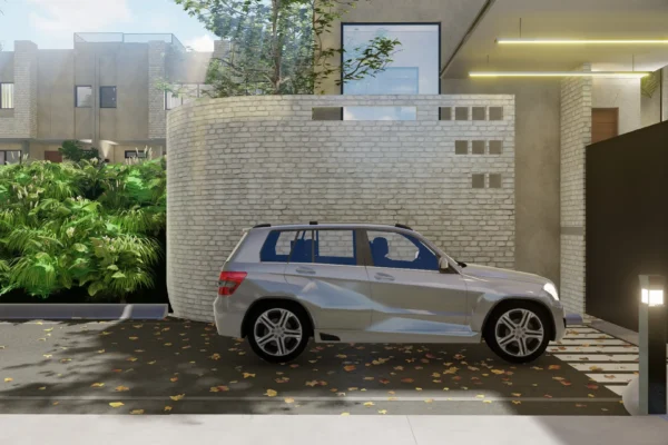 A driveway with a parked silver SUV in front of a modern light brick building surrounded by greenery.